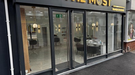 Modern salon exterior of THE MOST BEAUTY & AESTHETICS in Exeter, England, GB with stylish glass doors.