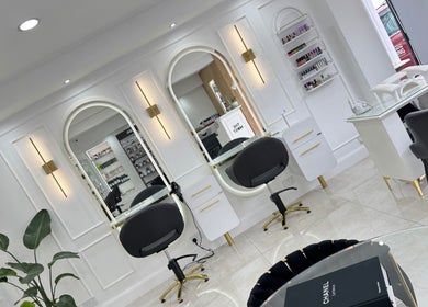Elegant interior of THE MOST BEAUTY & AESTHETICS in Exeter, England, showcasing modern styling stations.