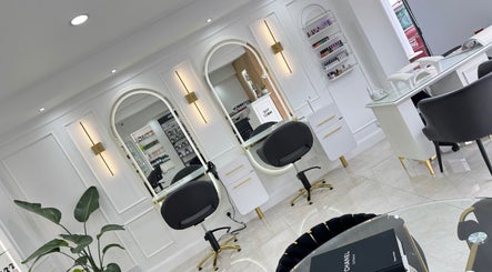 Elegant interior of THE MOST BEAUTY & AESTHETICS in Exeter, England, showcasing modern styling stations.