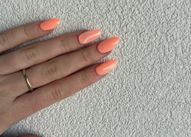 Vibrant coral manicure at Petal&Polish, Jimboomba, Queensland, AU showcasing stylish nail art.