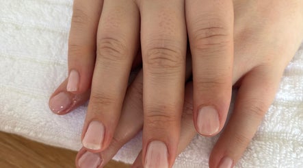 Freshly manicured hands at Petal&polish, Jimboomba, Queensland, AU. Soft pink nails on white towel.
