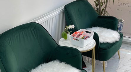 Elegant waiting area at MK Nails and Spa Fulham Ltd, London, England, GB, featuring plush green chairs and nail samples.