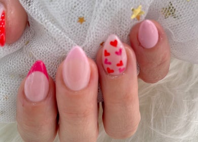 Stylish pink nails with heart designs at MK Nails and spa Fulham Ltd, London, England, GB.
