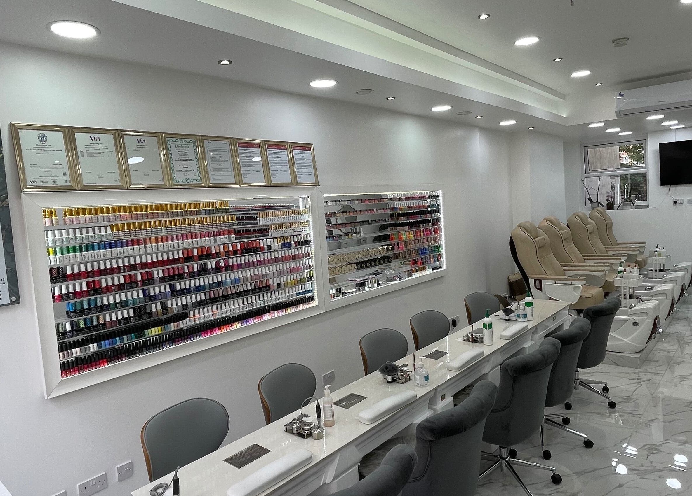 Chic interior of MK Nails and Spa Fulham Ltd, London, with nail polish display and luxurious pedicure chairs.