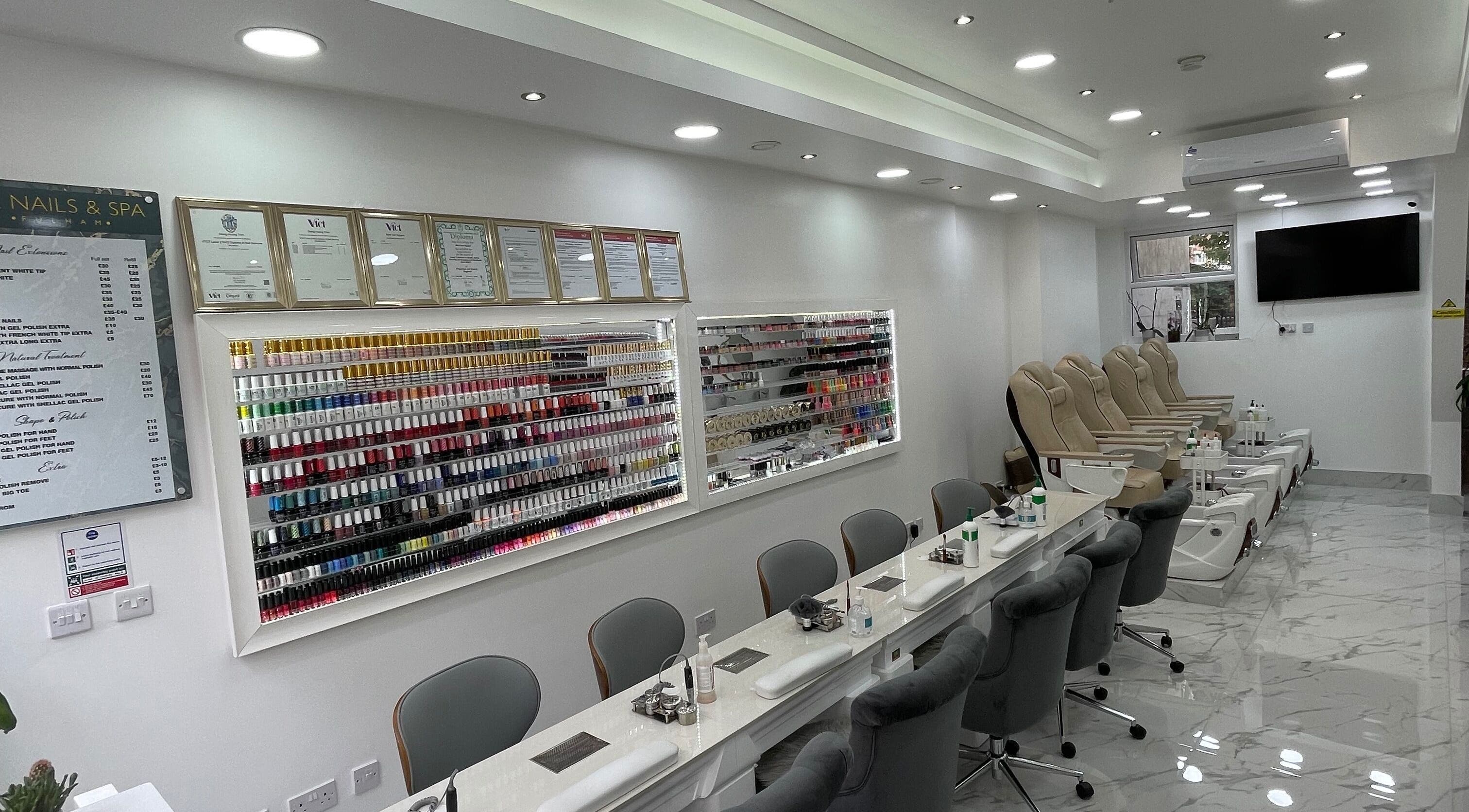 Chic interior of MK Nails and Spa Fulham Ltd, London, with nail polish display and luxurious pedicure chairs.