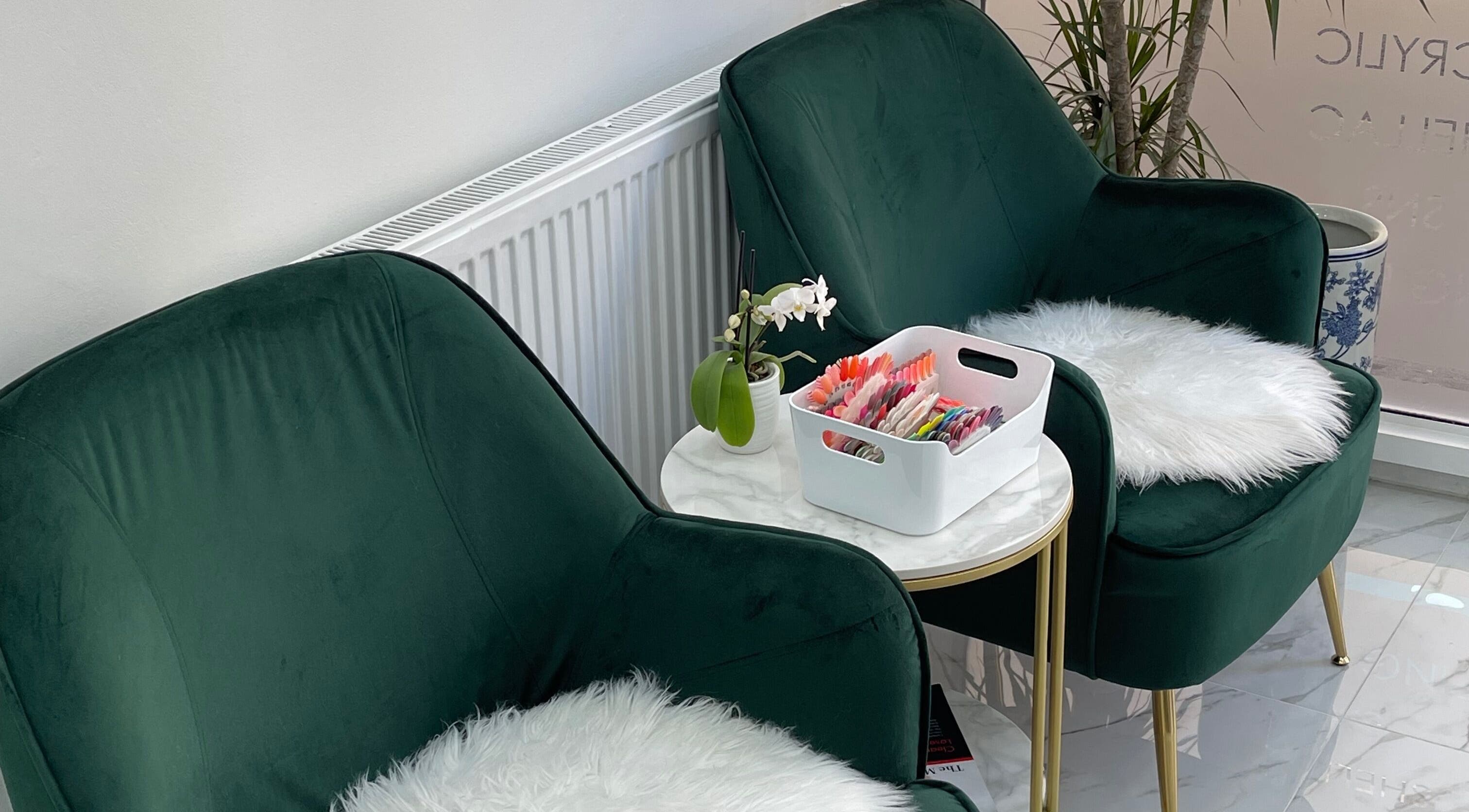 Elegant waiting area at MK Nails and Spa Fulham Ltd, London, England, GB, featuring plush green chairs.