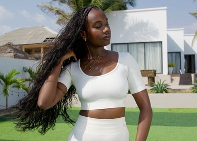 A woman with braided hair outside at Flex Flow Hair Mobile Braiding, Lagos, NG.