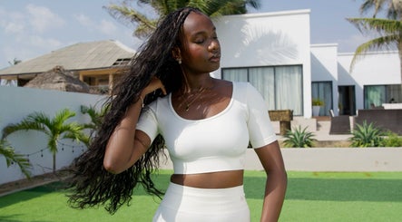 A woman with braided hair outside at Flex Flow Hair Mobile Braiding, Lagos, NG.