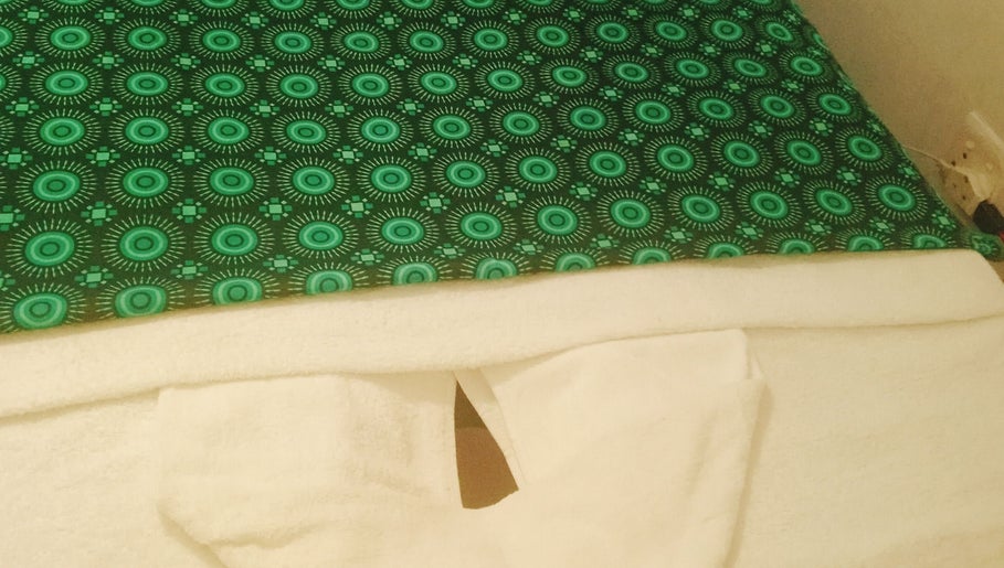 Relaxing massage table with green cover at Jojoesthaispa, Edenvale, Gauteng, ZA, offering serene wellness vibes.