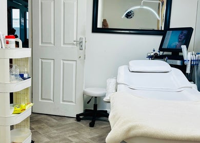 Elegant treatment room at Fama Aesthetics, Morden, England, GB, showcasing modern equipment and relaxing ambiance.