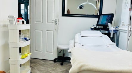 Elegant treatment room at Fama Aesthetics, Morden, England, GB, showcasing modern equipment and relaxing ambiance.