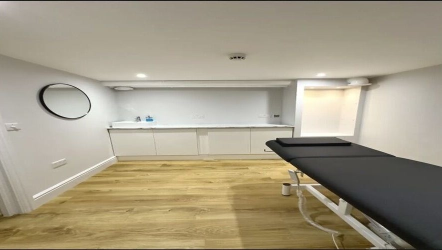 Modern treatment room at Aurelle Aesthetic Clinic, Gerrards Cross, England, GB with sleek design and comfortable bed.
