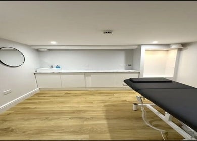 Modern treatment room at Aurelle Aesthetic Clinic, Gerrards Cross, England, GB with sleek design and comfortable bed.