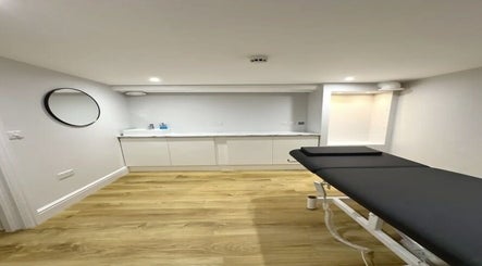 Modern treatment room at Aurelle Aesthetic Clinic, Gerrards Cross, England, GB with sleek design and comfortable bed.