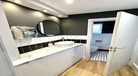 Elegant restroom in Aurelle Aesthetic Clinic, Gerrards Cross, England, GB with modern fixtures and decor.
