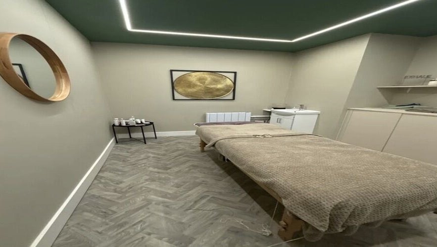 Elegant treatment room at Aurelle Aesthetic Clinic, Gerrards Cross, England, GB, with cozy bed and soothing decor.