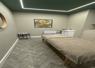 Elegant treatment room at Aurelle Aesthetic Clinic, Gerrards Cross, England, GB, with cozy bed and soothing decor.
