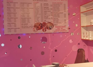 Kori's Massage and Beauty Spa vibrant pink interior showcasing services menu in Germiston, Gauteng, ZA.