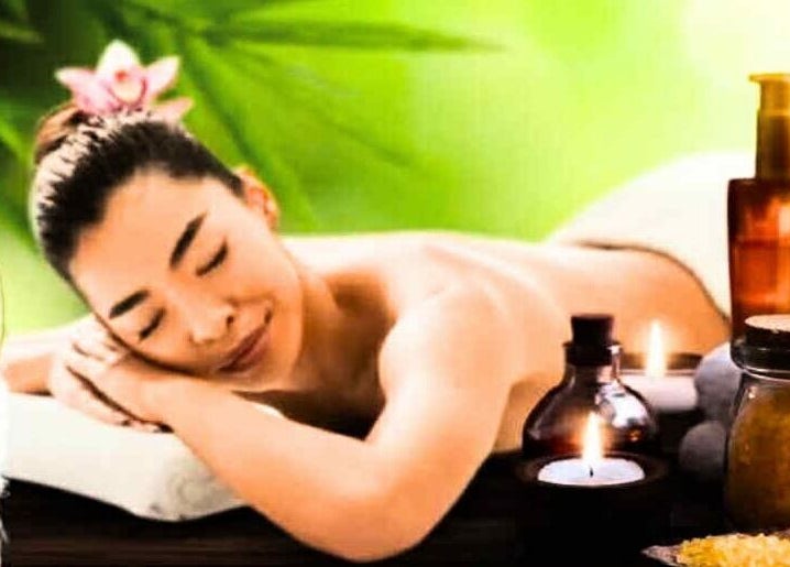 Relaxed woman enjoying massage at Annie Thai Massage, Egham, England, GB with soothing candles and oils.