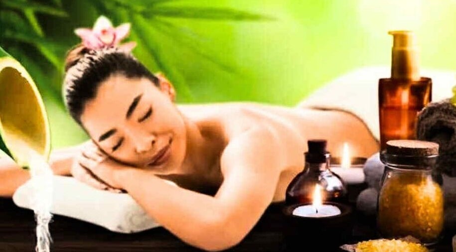Relaxed woman enjoying massage at Annie Thai Massage, Egham, England, GB with soothing candles and oils.