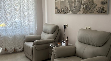 Relaxing chairs and serene decor in Orchid Spa, Rīga, LV, offering peaceful wellness experiences.