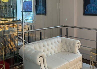 Elegant white sofa in Orchid Spa's chic lounge area, Rīga, LV.