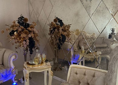 Elegant lounge of Orchid Spa, Rīga, LV featuring luxurious seating and mirrored decor.