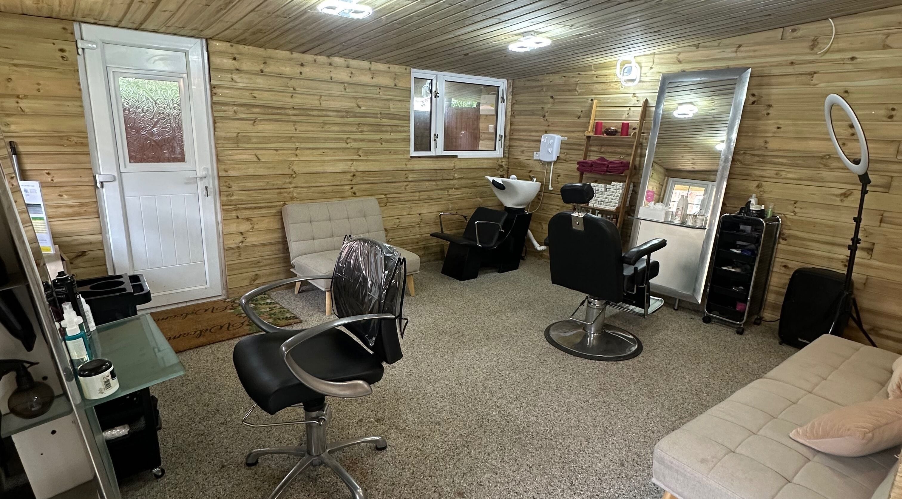 Interior of Hair and Beauty Cottage in Bristol, England featuring stylish chairs and mirrors.