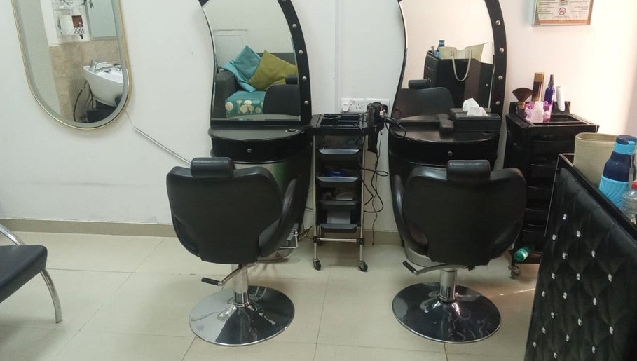 Styling stations at Sabeen Adnan Beauty Salon, Sharjah, Sharjah, AE, featuring elegant salon chairs and mirrors.