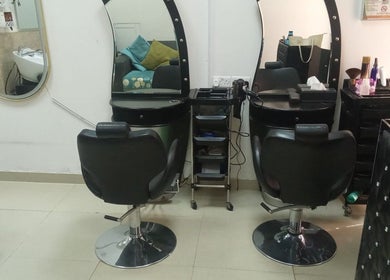 Styling stations at Sabeen Adnan Beauty Salon, Sharjah, Sharjah, AE, featuring elegant salon chairs and mirrors.