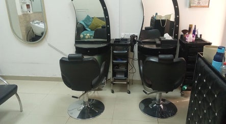 Styling stations at Sabeen Adnan Beauty Salon, Sharjah, Sharjah, AE, featuring elegant salon chairs and mirrors.