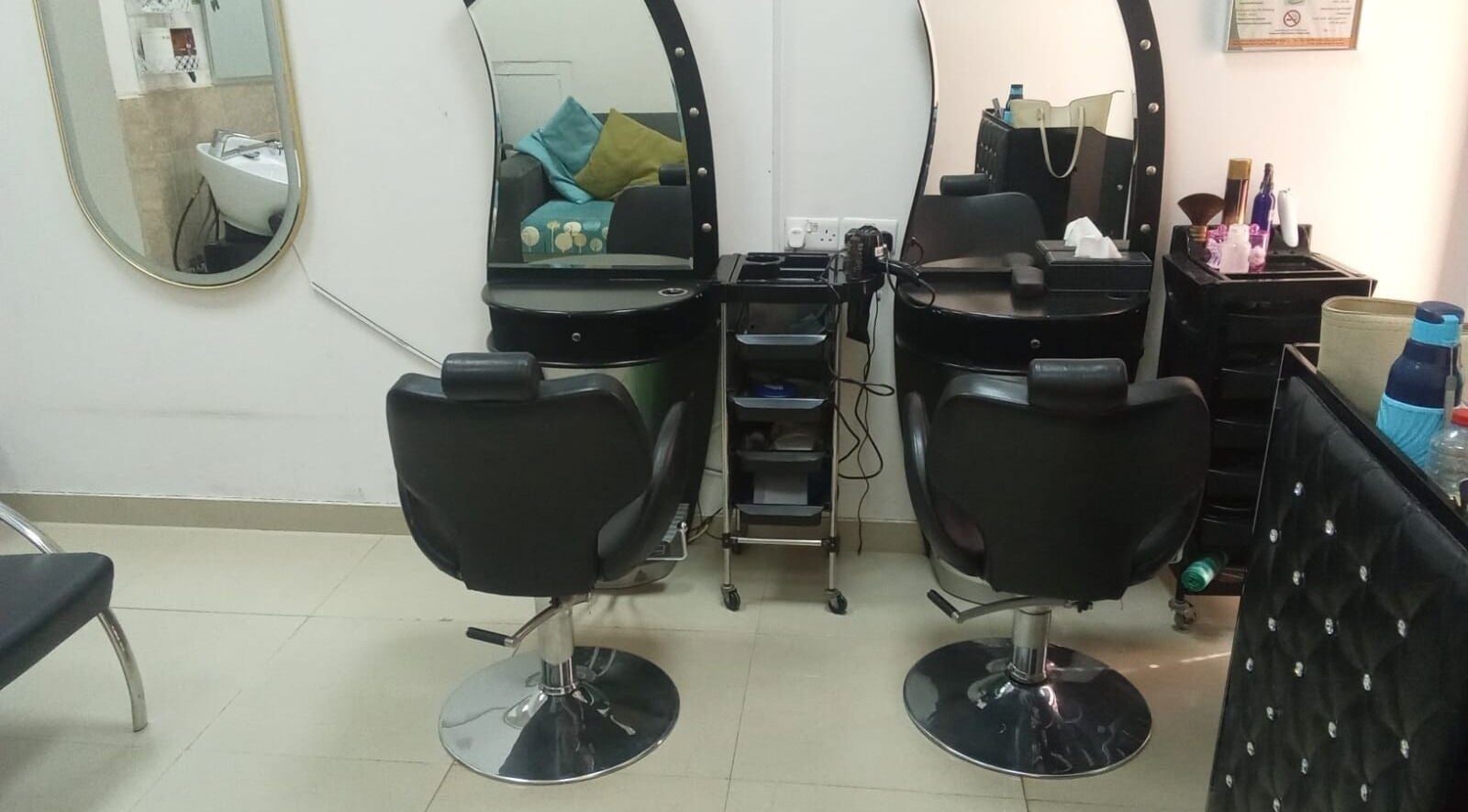 Styling stations at Sabeen Adnan Beauty Salon, Sharjah, Sharjah, AE, featuring elegant salon chairs and mirrors.