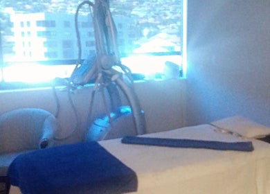 Relaxing treatment room at Virgors beauty center in Cape Town, Western Cape, ZA, overlooking cityscape.