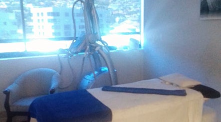 Relaxing treatment room at Virgors beauty center in Cape Town, Western Cape, ZA, overlooking cityscape.