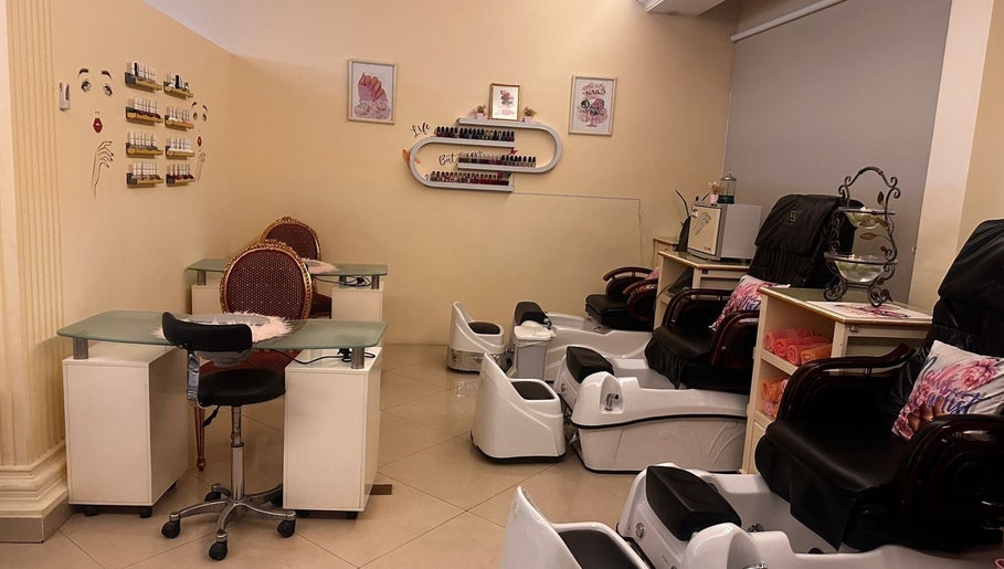 Cozy interior of Ivari Beauty Centre at Ras Al-khaimah, showcasing pedicure chairs and nail stations.
