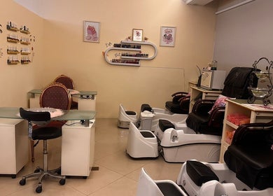 Cozy interior of Ivari Beauty Centre at Ras Al-khaimah, showcasing pedicure chairs and nail stations.