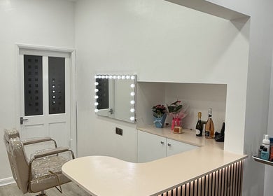 Sleek interior of Diva’s Beauty Studio in Hull, England, GB featuring elegant decor and a well-lit vanity mirror.