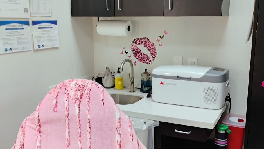 Cozy treatment area at Soul Pretty Aesthetics, Gilbert, Arizona, US. Features pink decor and modern equipment.