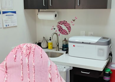 Cozy treatment area at Soul Pretty Aesthetics, Gilbert, Arizona, US. Features pink decor and modern equipment.