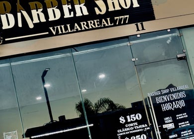 Entrada de Barber Shop Villarreal en García, Nuevo León, MX con letrero y precios visibles.