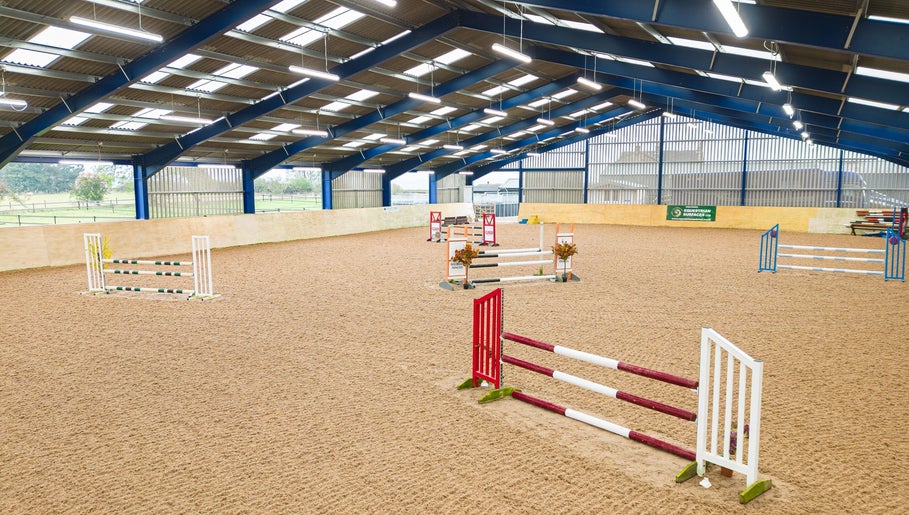 Indoor equestrian arena at Marwood Equestrian, Barnard Castle, England, GB with various jumps.