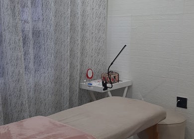 Cozy treatment room at On The Glow, Midrand, Gauteng, ZA featuring a massage table and elegant decor.