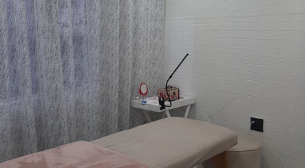 Cozy treatment room at On The Glow, Midrand, Gauteng, ZA featuring a massage table and elegant decor.