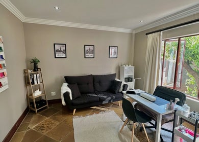 Nail lounge at Nude by Nicole, Kempton Park, Gauteng, ZA with plush seating and a vibrant polish display.