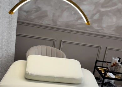 Elegant treatment room at Skin Luse, Hazel Grove, England, GB featuring a modern spa bed and essentials cart.