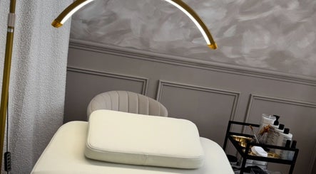 Elegant treatment room at Skin Luse, Hazel Grove, England, GB featuring a modern spa bed and essentials cart.