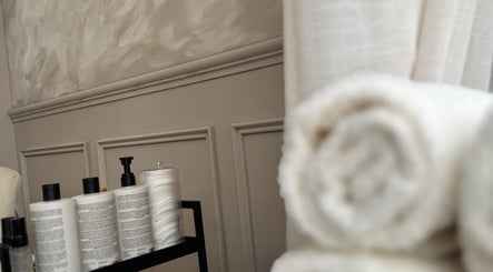 Beauty products and towels at Skin Luse, Hazel Grove, England, GB showcase serene ambiance.