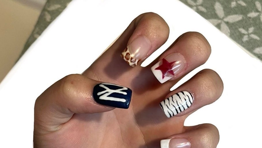 Vibrant nail art at Beauty By Imogen, Bridport, England, GB featuring diverse designs on manicured nails.