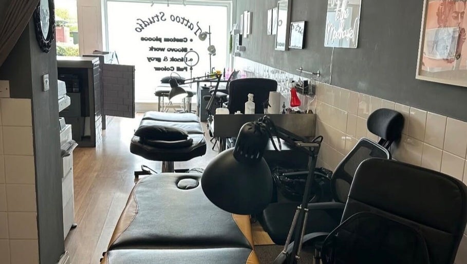 Interior of Mind Over Matter Tattoo Studio in Hazel Grove, England, featuring tattoo stations and sleek decor.