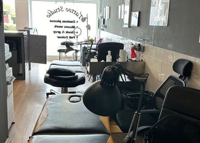 Interior of Mind Over Matter Tattoo Studio in Hazel Grove, England, featuring tattoo stations and sleek decor.